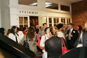 0166 Members and guests enjoy conversation and the ambiance of the Steinway showroom