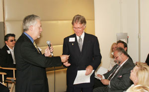 9747 Phil Garrett of Mercedes Smart Car hands over the keys for a complimentary weekend use of a smartcar for the weekend to John Brantley of Gumps